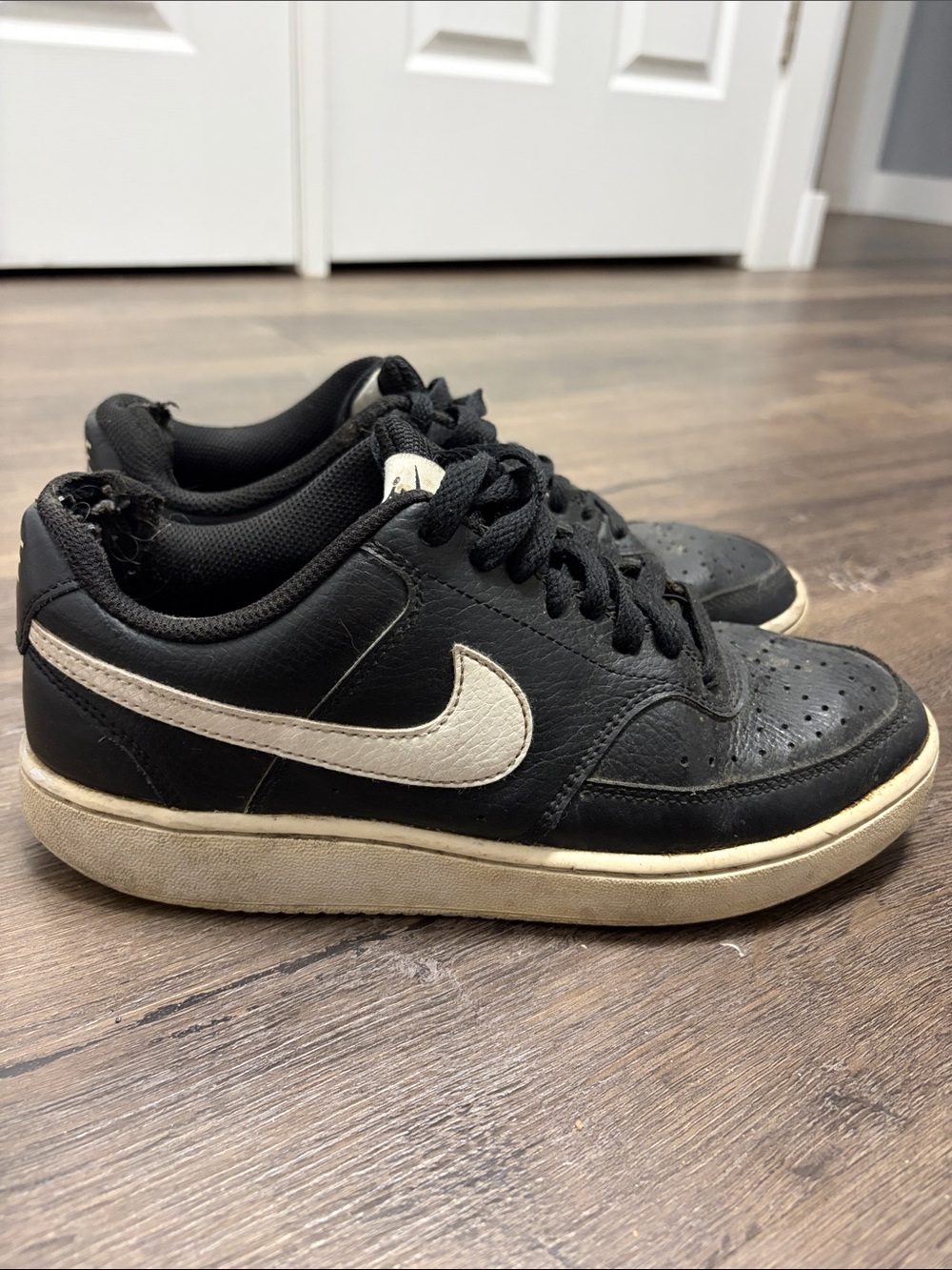 Nike womens Black Sneakers with White Swoosh